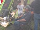Viewing through the tent window:
Doug K6JEY teaching a youngster how to operate the Elecraft K3 on 10m SSB. KH6WZ photo.